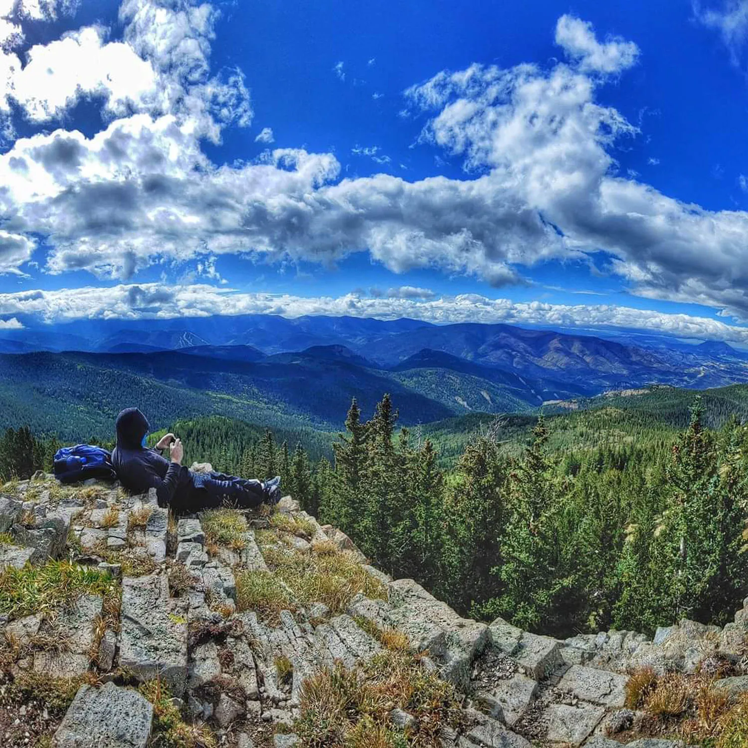 John Frazee enjoying mountain vista with blue skies